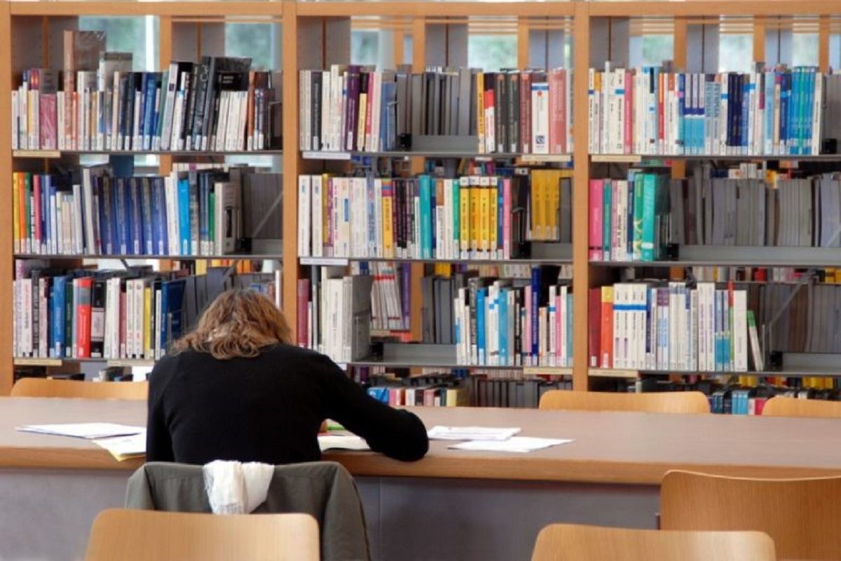 Une étudiante dans une bibliothèque universitaires 1deae